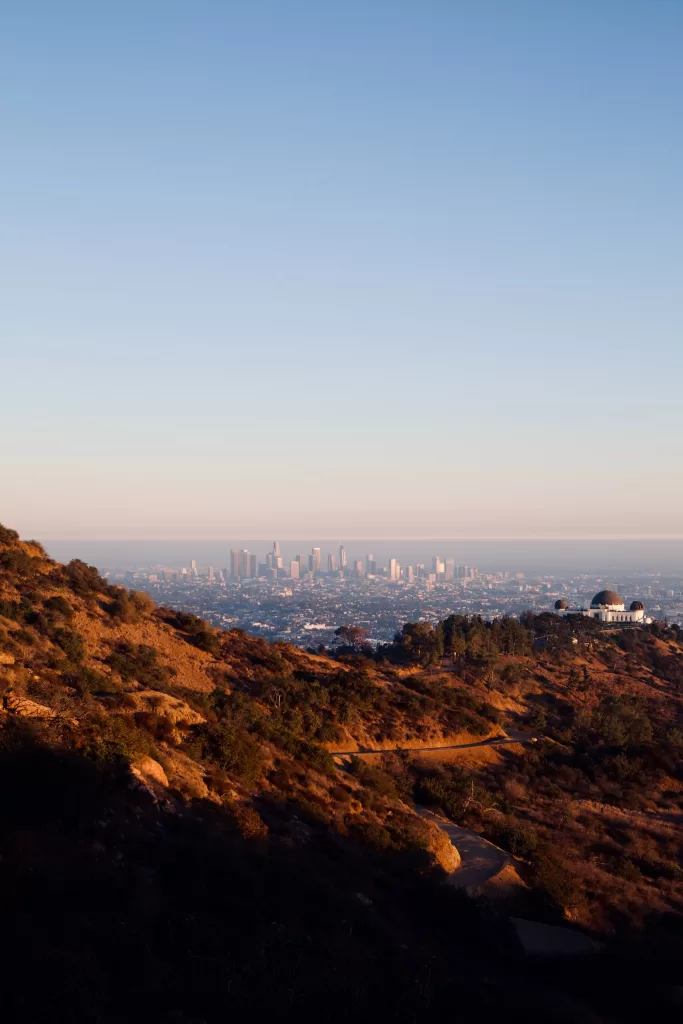 Griffith Observatory building with surrounding hills and city view