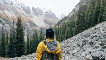 Photo by Rachel Claire: https://www.pexels.com/photo/traveler-standing-on-stones-in-mountainous-terrain-4993107/ with hiking clothes