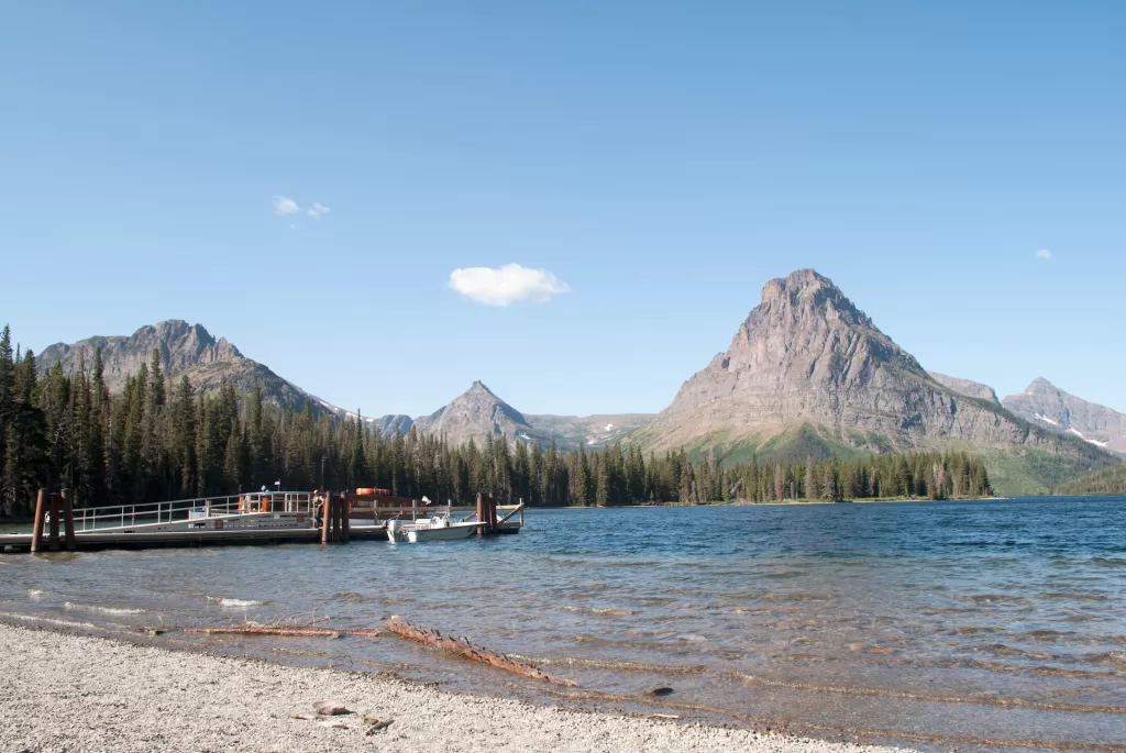 A picturesque lake surrounded by towering peaks in Glacier National Park