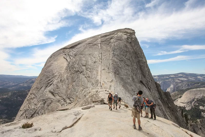 Hiking Half Dome
The line up the center is a ~400 ft ascent to the summit at a 45º angle, aided by two thick braided cable railings. An average of 2 people a year die on this part of the hike.

